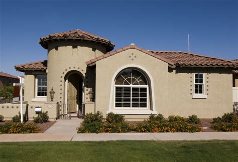 Beautiful tan home with earth tones colors and trims. . Tan stucco house with brown trim